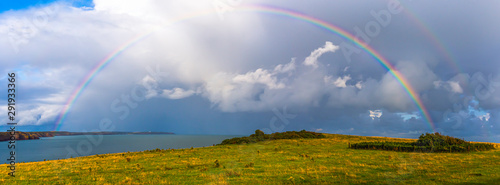Tableau sur toile Moody sky with full rainbow bridge on british coast, South Wales, Uk