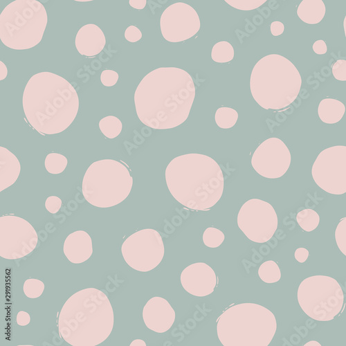 Shabby chic irregular polka dots vector seamless pattern. Trendy seamless pattern with pink dots on light green background. Vector illustration. Surface pattern design.