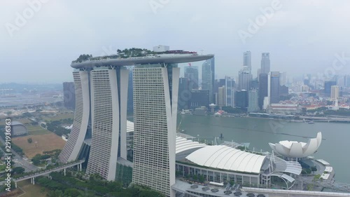 Travelling aerial shot of Marina Bay Sands with Singapore City Skyline as background during Cloudy day