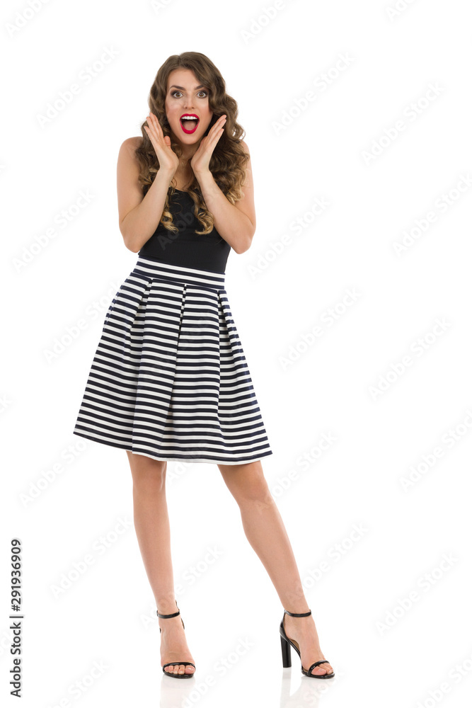 Surprised Sexy Woman In Striped Skirt And High Heels Is Holding Head In Hands And Talking Surprised Sexy Woman In Striped Skirt And High Heels Is Holding Head In Hands And Talking