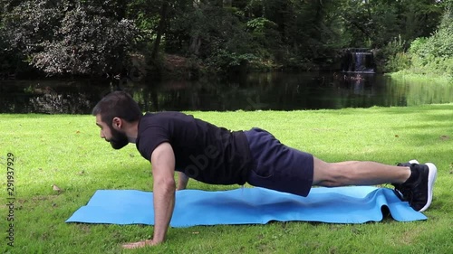 Man doing push ups wide grip in park