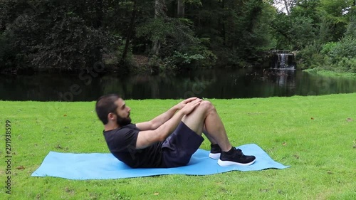 Man sit ups in park arms on legs