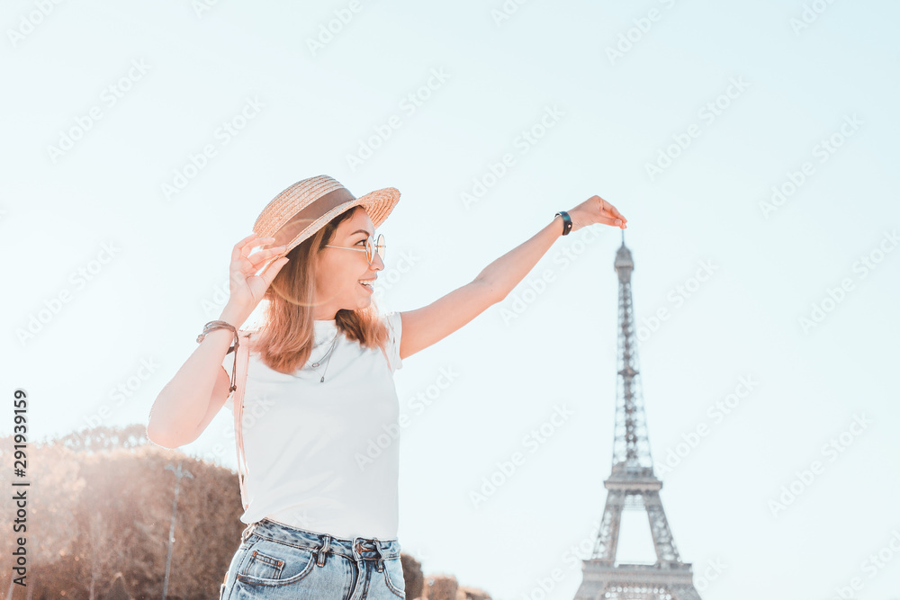 Fotografie Happy asian woman traveler posing at Mars Field at the background of majestic Eiffel tower