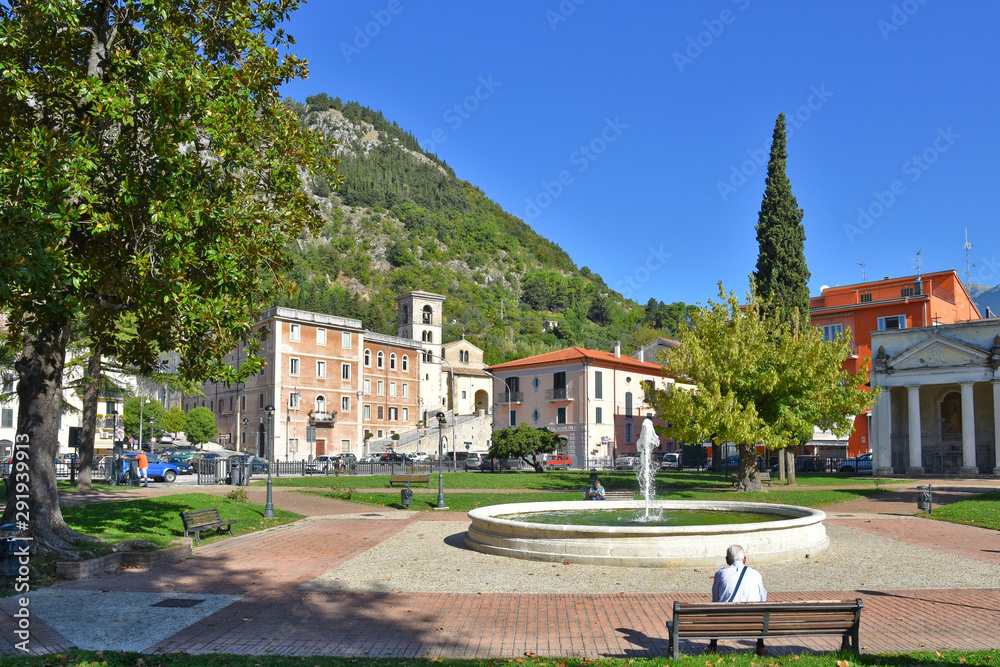 A public fountain in the square of an old Italian village