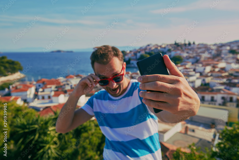 Modern man using cellphone and enjoying the view. Modern man using cellphone and enjoying the view.