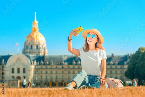 Canvas Print Asian happy girl traveler taking selfie pictures in the square near the Invalides In Paris