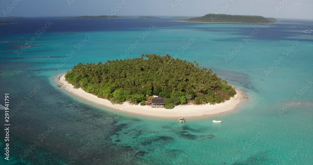 Aerial view of a scenic landscape of desert island with white sand beach and crystal clear sea water bay. 