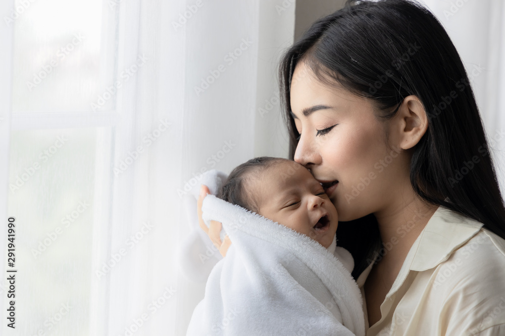 Stockfoto Portrait of asian young mother kissing her cute newborn baby ... picture photo