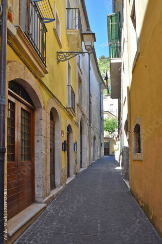 A narrow street among the old houses of a medieval village. © Giambattista