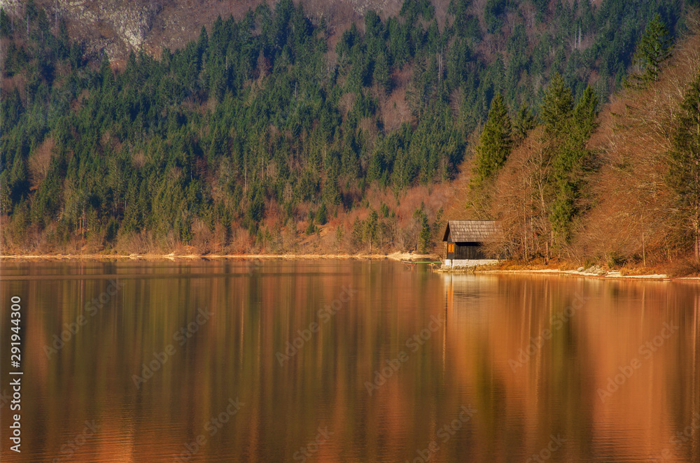 Autumn reflections on lake Bohinj, Julian Alps, the largest permanent lake in Slovenia