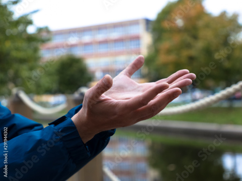 hands with palms up on urban background