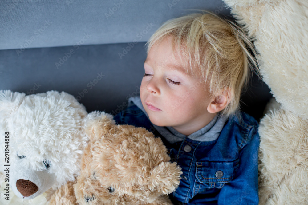 Blond toddler boy, sleeping with many teddy bears in the afternoon Blond toddler boy, sleeping with many teddy bears in the afternoon