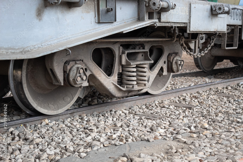 Closed Up to Cargo Train Car Undercarriage in Railroad with Stones Closed Up to Cargo Train Car Undercarriage in Railroad with Stones
