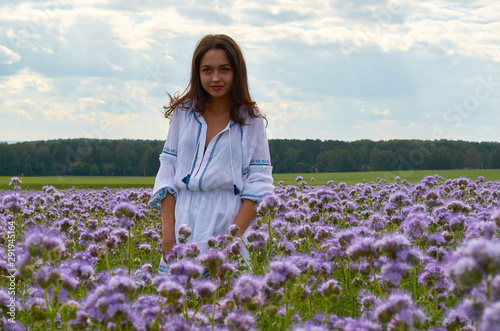 girl in white dress in a field of flowers