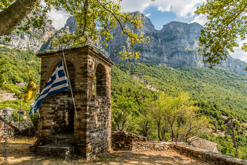 Bell tower of Taxiarchon church in the village of micro Papingon, Ioannina, Greece photo