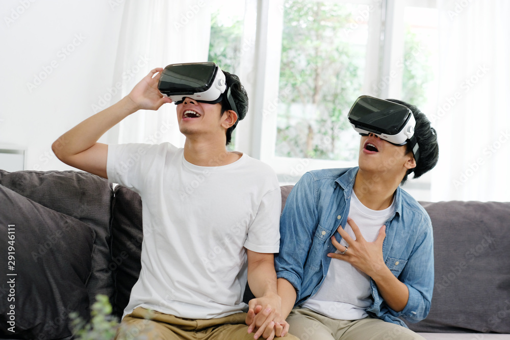 Young asian men, gay couple playing VR with happiness at home living room,  Asia boys wearing VR glasses to play virtual simulator, Homosexual, lgbt  couple lifestyle foto de Stock | Adobe Stock
