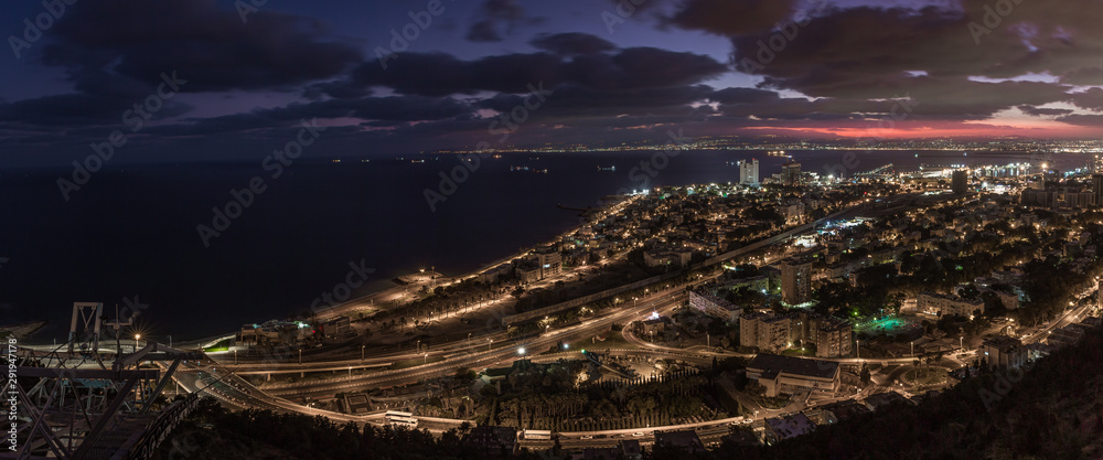 Night view in the light of lanterns from Mount Carmel to the downtown and the seaport of Haifa located on the shores of the Mediterranean Sea