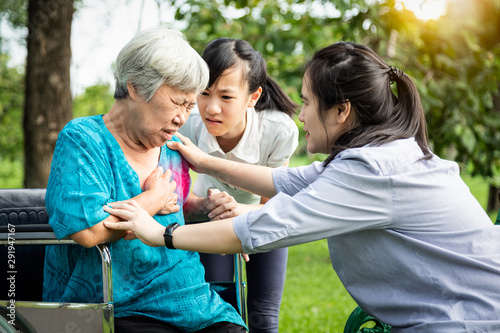 Asian senior having panic disorder suffering an anxiety attack with the hands in ,mental health problem,depressed elderly woman having heartbeats fast,heart palpitation,shortness of breath at park