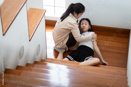 Asian beautiful child girl in coma on floor feeling unconscious after accident,falling down from fell or slipped to the floor because of dizziness,faint,suffering from illness,mother to help,care,