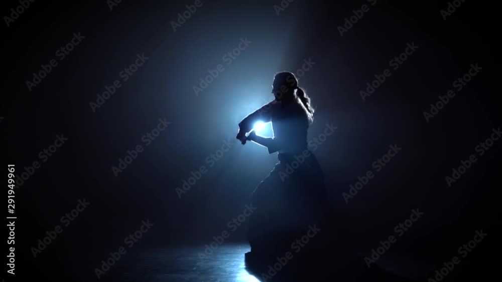 Silhouette martial arts Aikido master on spotlight background. Silhouette martial arts Aikido master on spotlight background.