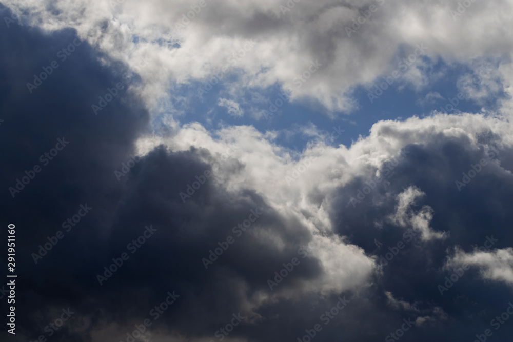 Thunderclouds on blue sky background.