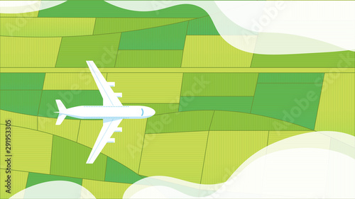 Passenger plane top view flying above green grassland.
