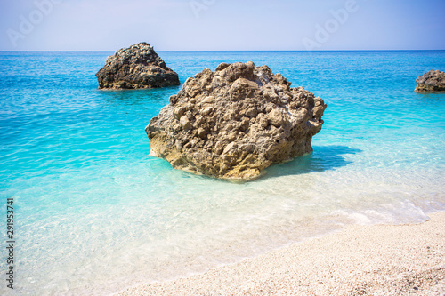 Beautiful sandy beach with turquoise water and big rocks