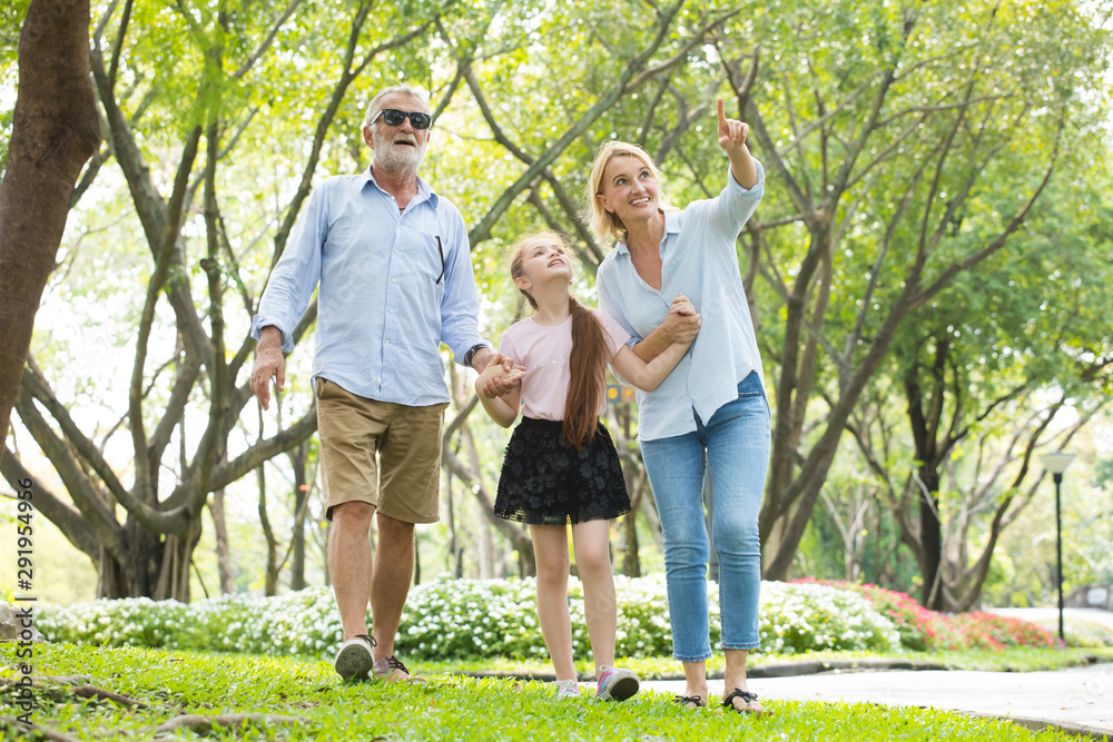 Obraz premium Happy male and female playing with children in park
