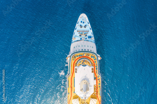 Close up aerial top view nose of the cruise ship in the turquoise sea. Concept of summer sea cruise tours.