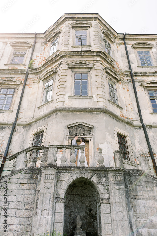 Happy loving Asian couple. Wedding, love story and friendship concept, Asian couple standing face to face on the balcony on the old castle