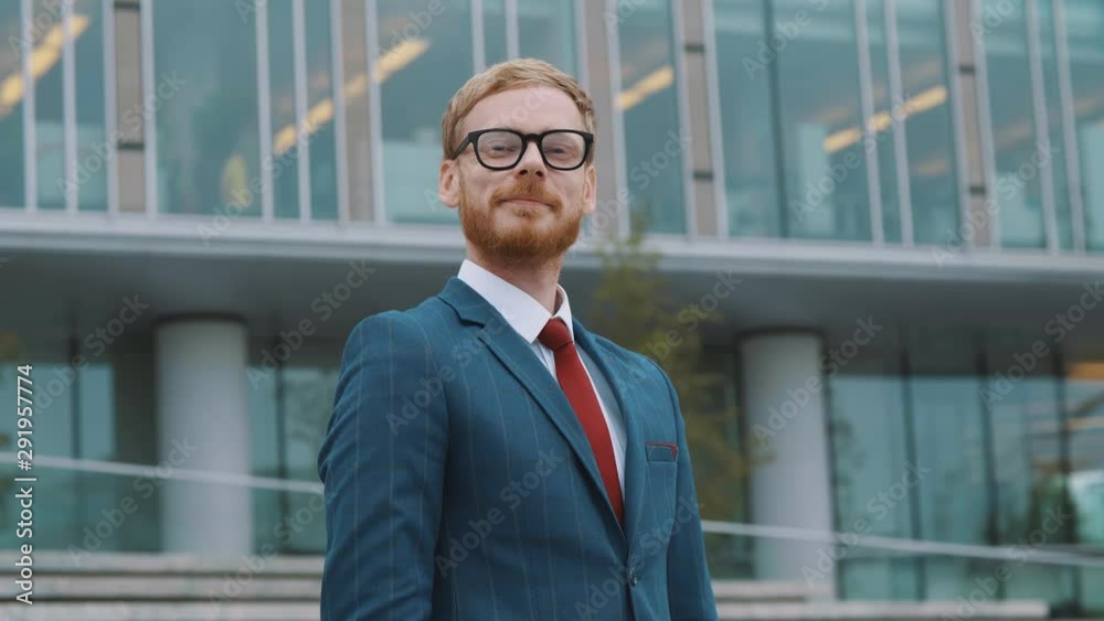 Young successful businessman standing outside Young successful businessman standing outside