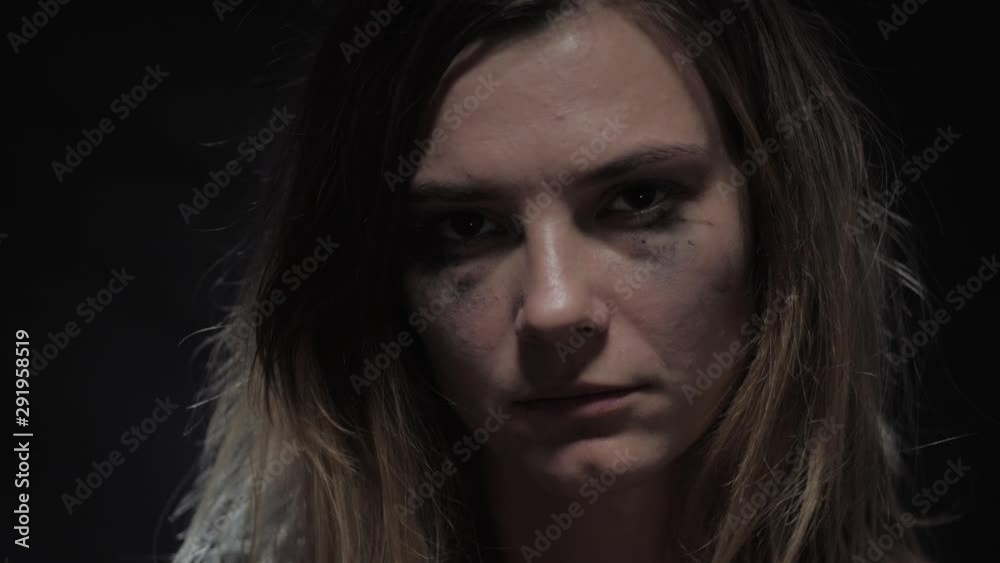 sad and crying woman victim suffers from domestic violence in the family, sorrowfully looks at the camera and shows quietly, shhh! social family problem sad and crying woman victim suffers from domestic violence in the family, sorrowfully looks at the camera and shows quietly, shhh! social family problem