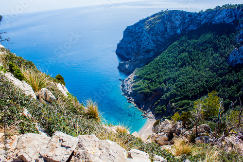 Fotografie, Obraz Mallorca blue lagooon panorama view with Mountains and green forest and blue sky