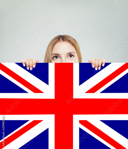 Portrait of happy pretty girl with UK flag background. Young wom