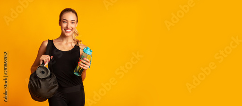 Fototapeta Naklejka Na Ścianę i Meble -  Woman Holding Fitness Bag Ready For Training, Studio Shot, Panorama