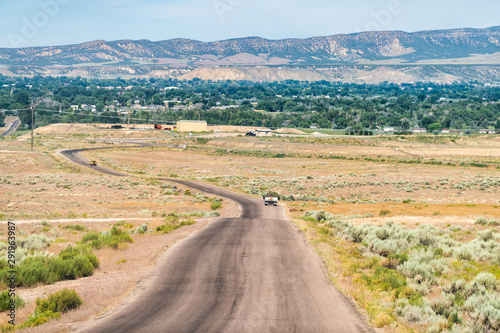 Jensen or Vernal Utah road highway with view of city near Dinosaur National Monument desert landscape photo