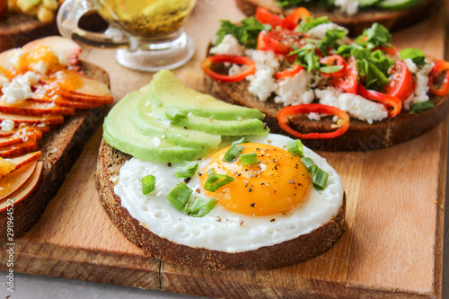 Useful sandwiches stuffed with avocado, scrambled eggs, cottage cheese and fruit