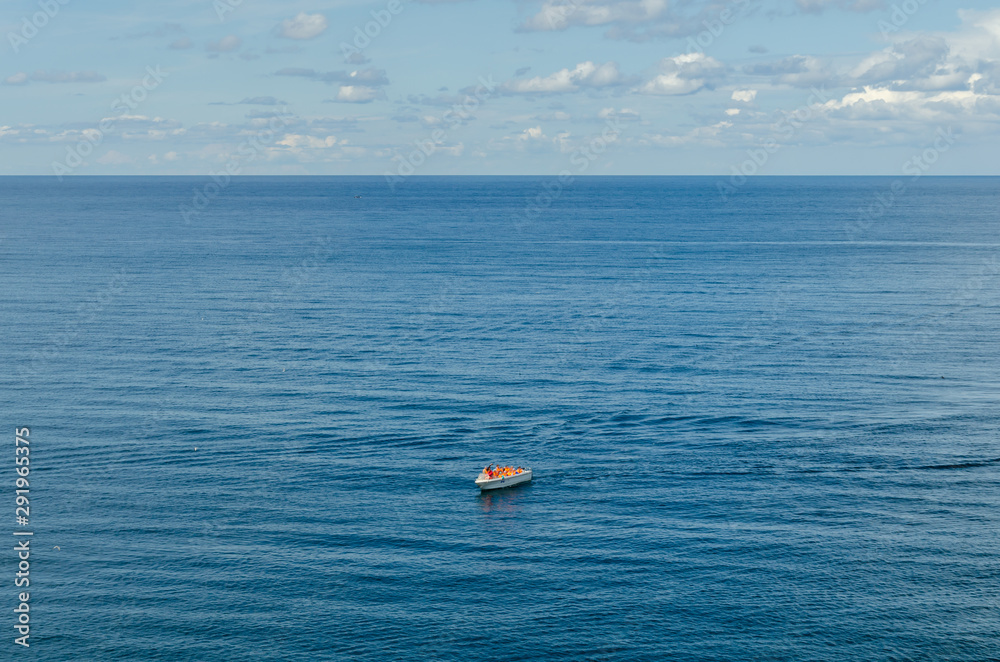 A lifeboat with people in the open sea.