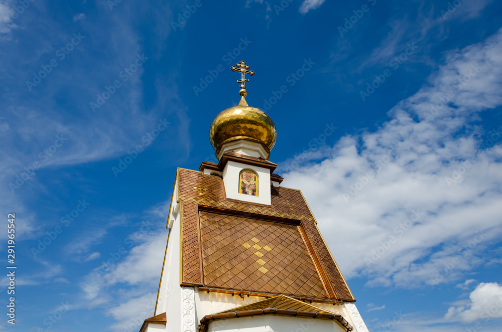 Old Christian Church with Golden dome in summer.