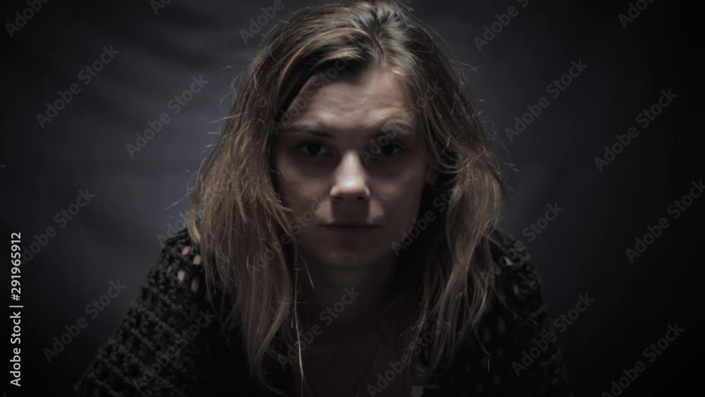 sad lonely woman looking at the camera with a look full of despair, concept of depression