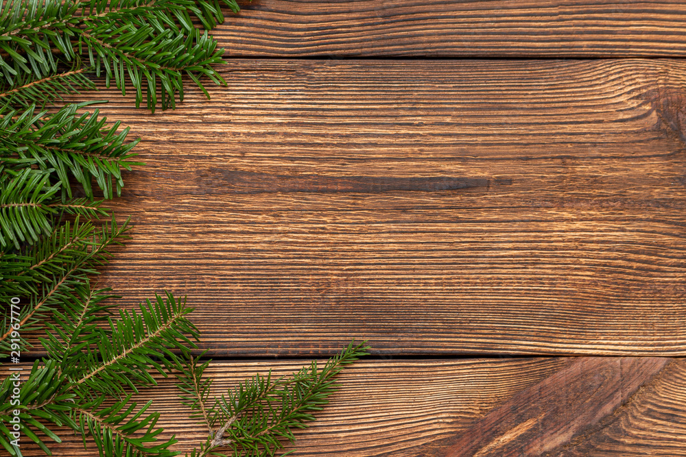 Fur spruce pine coniferous branches on the brown brushed wooden background Fur spruce pine coniferous branches on the brown brushed wooden background