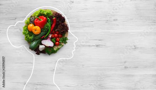Fototapeta Naklejka Na Ścianę i Meble - Fresh vegetables in woman head symbolizing health nutrition