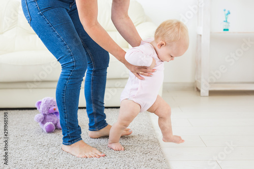 First steps. Little baby girl learning to walk.