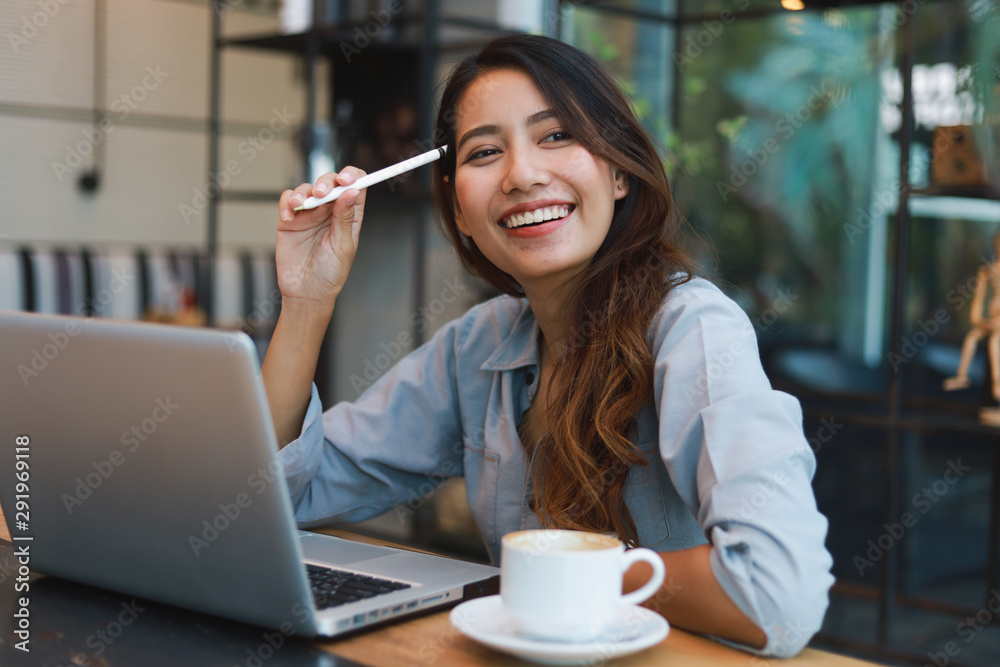 Φωτογραφία Asian woman in blue shirt working and drink coffee in coffee shop cafe vintage c