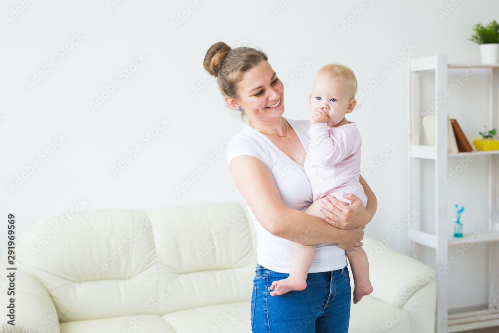 Mother hugs little baby. Happy woman with her daughter Mother hugs little baby. Happy woman with her daughter