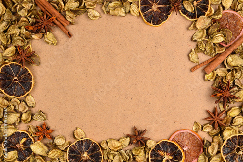 Autumn background with golden leaves, dried fruts, cinnamon and anis. Space for text or design.