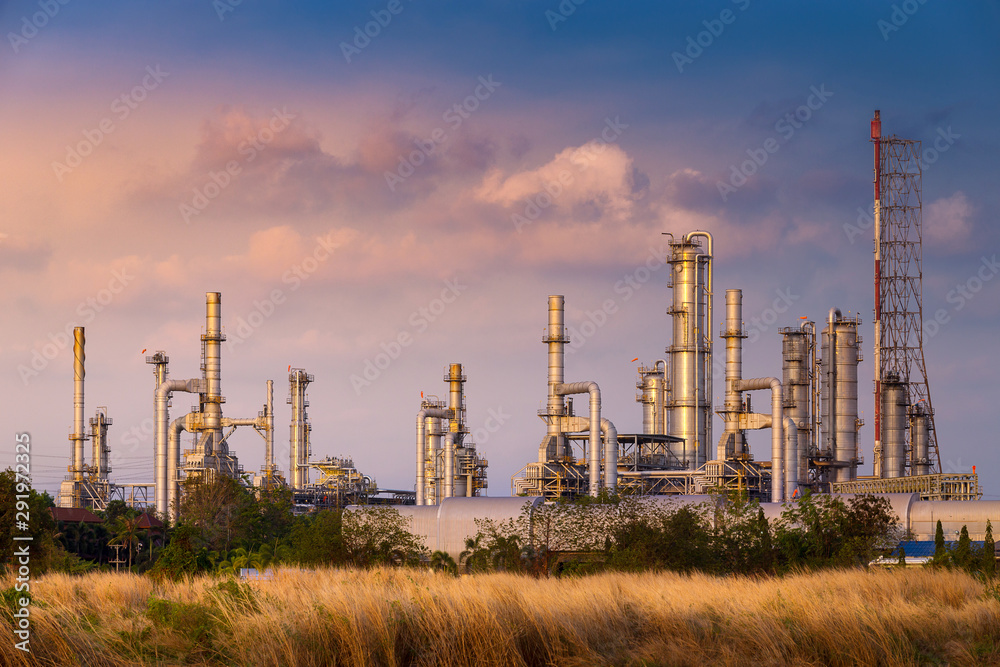 sunset time with agriculture field and chemical plant petrochemical and petroleum plant with reactor and distillation in refinery for chemical process in industrial area