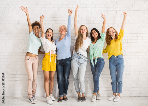 Diverse Women Waving Hands Standing Against White Wall Indoor
