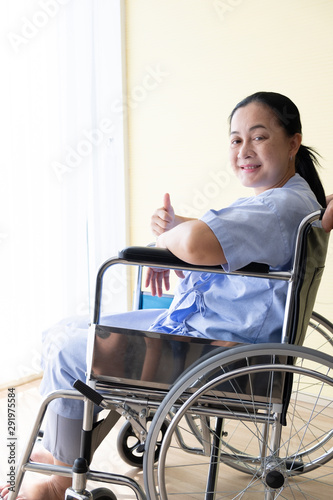 Patient sitting in a wheelchair with good encouragement, She lifted her finger and smiled.