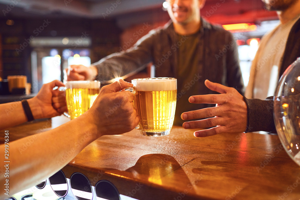 Crop bartender giving beer to men